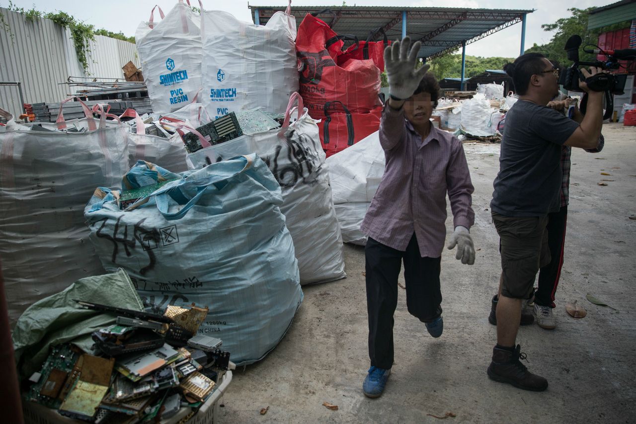 Towering bags of e-waste at a junkyard in Hong Kong.