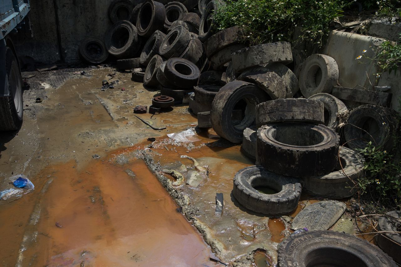 Discarded tires and dirty water at a junkyard in Hong Kong.