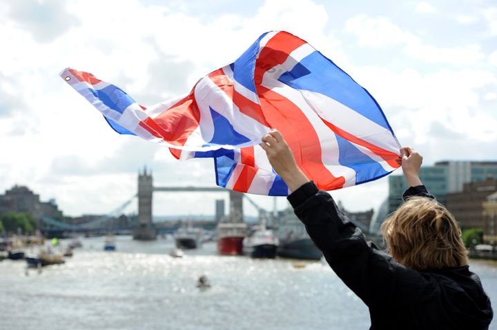 A leave supporter is seen as fishing boats campaigning for Brexit sail down the Thames through central London, United Kingdom on June 15, 2016.