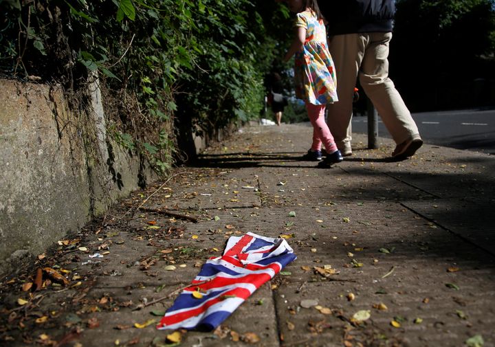 A British flag which was washed away by heavy rains the day before lies on the street in London, Britain, June 24, 2016 after Britain voted to leave the European Union in the EU Brexit referendum.