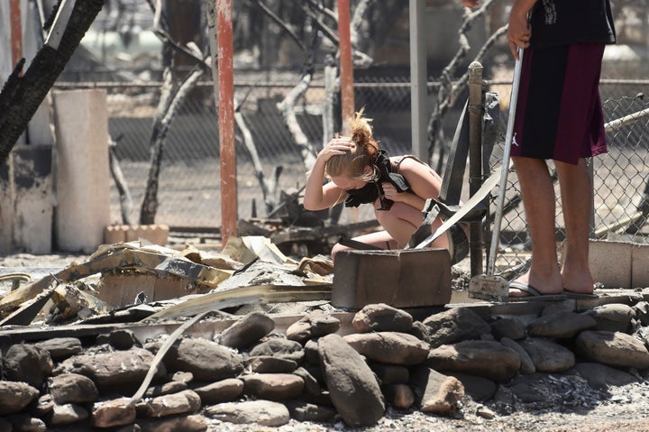 Brittany Thompson cries after finding a deceased dog at a burned down residence after the Erskine Fire burned through South Lake, California, U.S. June 24, 2016.