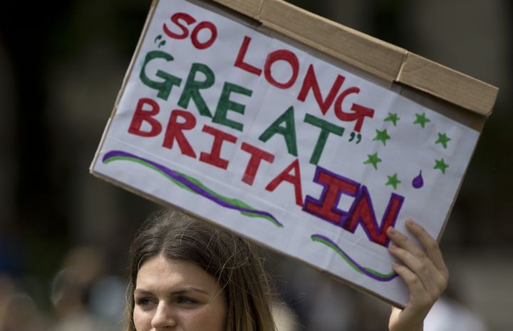 A demonstrator holds a placard reading 'So Long Great Britain' during a protest against the outcome of the UK's June 23 referendum.