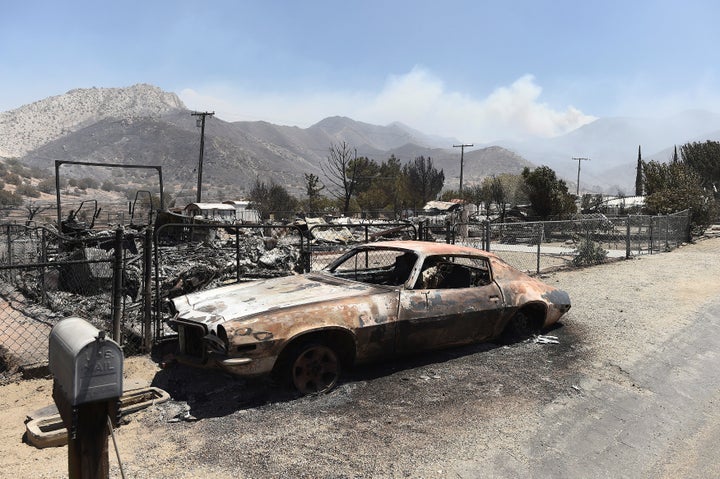 A scorched car sits among leveled homes after the Erskine Fire burned through South Lake, California, U.S. June 24, 2016.