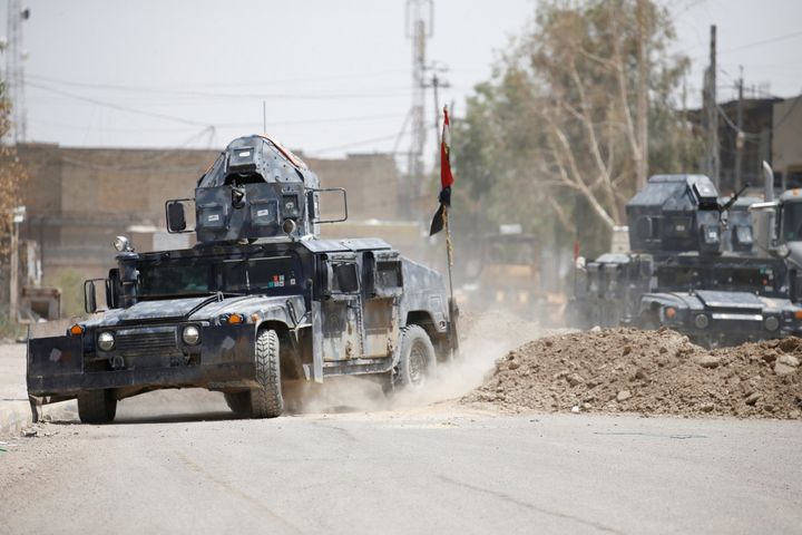 Military vehicles of Iraqi security forces are seen in Falluja, Iraq, June 25, 2016. (REUTERS/Thaier Al-Sudani)