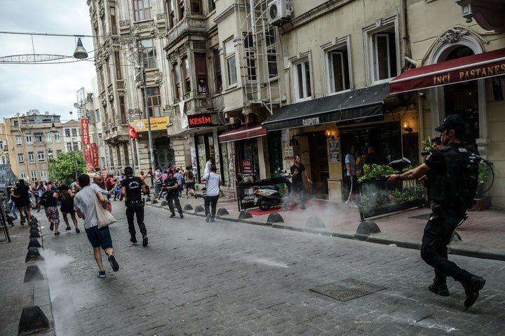 Turkish anti-riot police officers fire rubber bullets to disperse demonstrators gathered for a rally staged by the LGBT commu