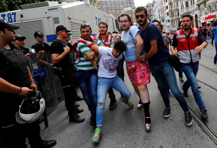 Plainclothes police officers detain LGBT rights activists as they try to gather for a pride parade, which was banned by the governorship, in Istanbul, Turkey, June 26, 2016. (REUTERS/Murad Sezer)