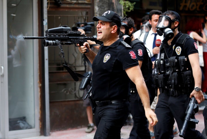 Riot police use rubber pellets to disperse LGBT rights activists as they try to gather for a pride parade, which was banned b