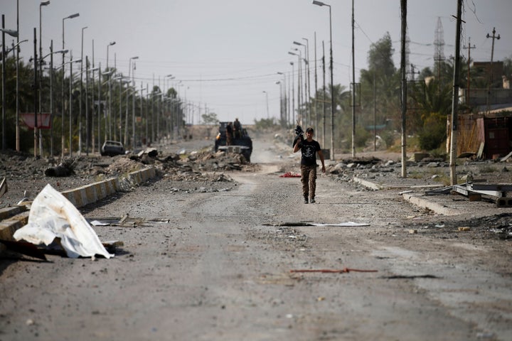 A member of Iraqi counterterrorism forces walks with his weapon in Falluja.