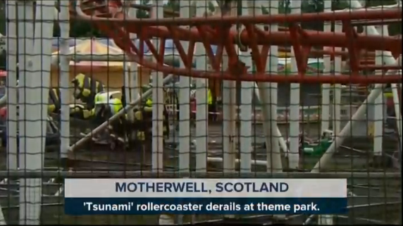 Wreckage from the crash is seen through a fence at the park in Scotland.