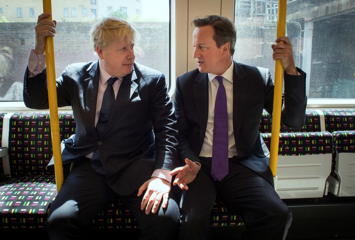 Britain's Prime Minister David Cameron and Boris Johnson sit on an underground train as they head to Westminster after local election campaigning in 2014. 