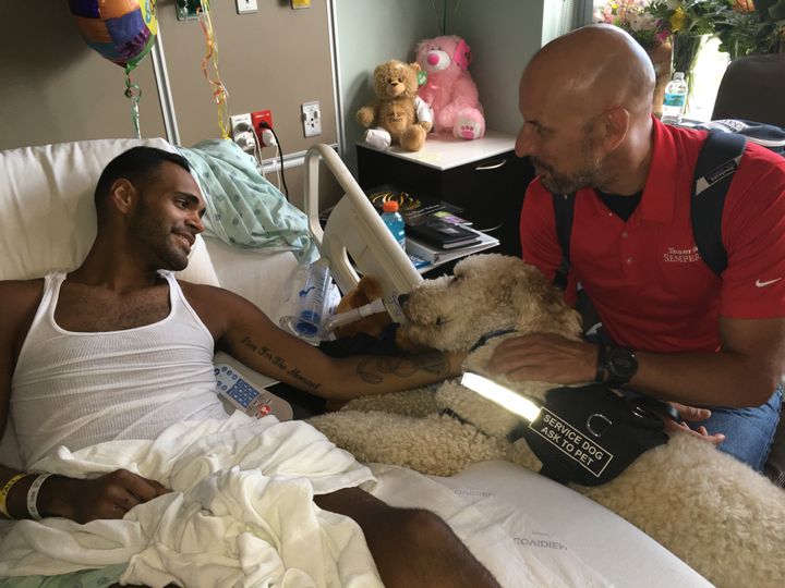 Boston bombing survivor Dave Fortier and his service dog Zealand visit Angel Colon, Pulse shooting survivor is visited in his hospital room.