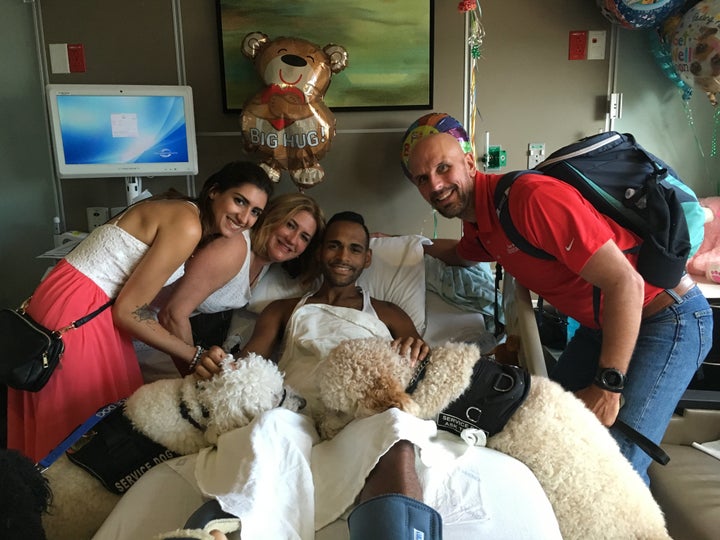 Boston survivors along with service dogs Koda and Zealand pose with Pulse survivor Angel Colon. 