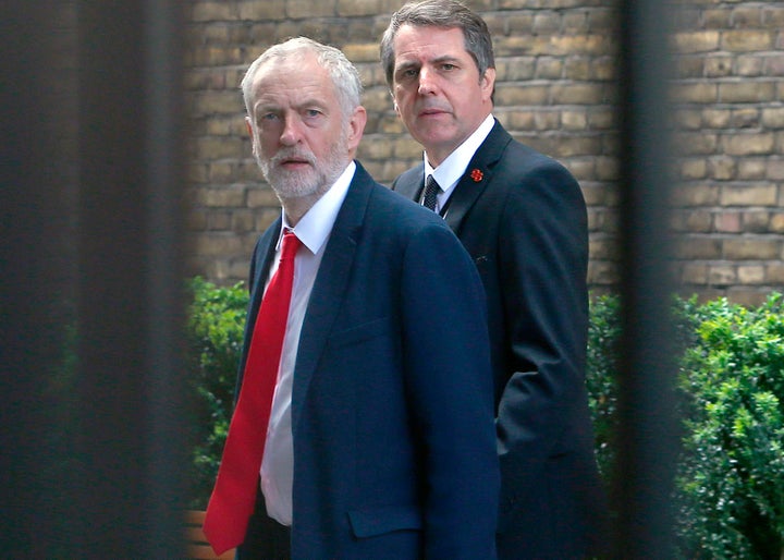 Jeremy Corbyn (L) walks to attend a meeting at the House of Commons. Corbyn has been embattled over the weekend from infighting within the Labour Party.