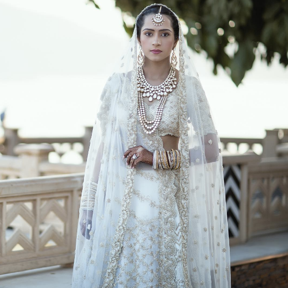 "I knew that this lehenga was going to be white and gold but I wanted it to have my signature designs whilst still being traditional," the bride wrote in a blog post.