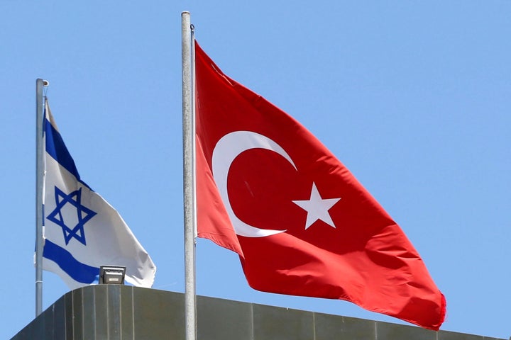 Turkish and Israeli flags on top of the Turkish embassy in Tel Aviv on June 26.