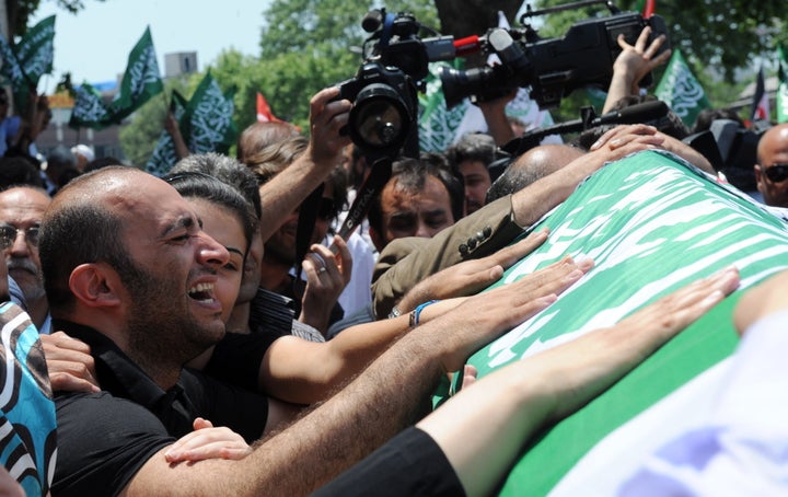 Relatives mourn as the coffin of Cevdet Kiliclar, killed by Israeli forces during a raid on a flotilla carrying aid to Gaza, is carried along during a funeral service after Friday prayers at Beyazit Mozque in Istanbul on June 4, 2010.