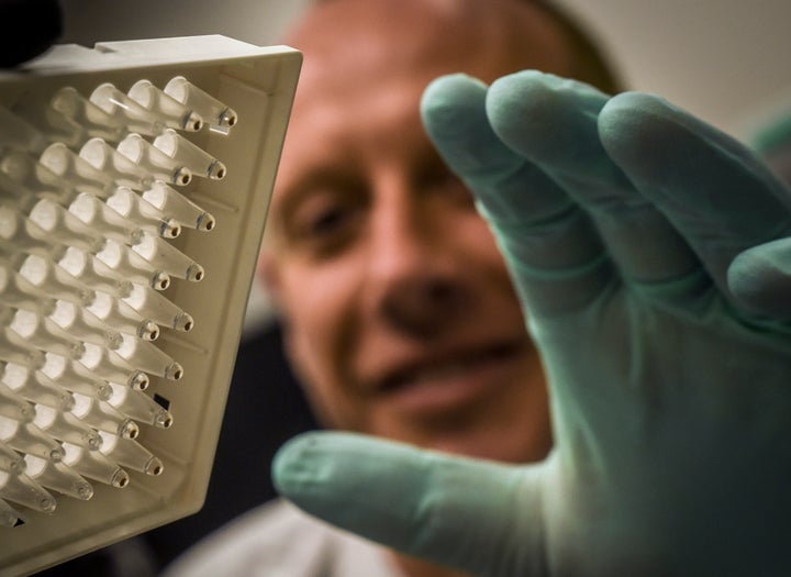 Dr. McGann, pictured, is seen checking a DNA sampling at the Walter Reed annex in Silver Spring, Maryland in late May.