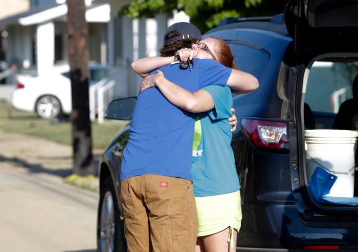 Ami Palmer, 40, hugs her nephew Landon Palmer upon returning to her home in Clendenin, West Virginia, which was damaged by flooding.