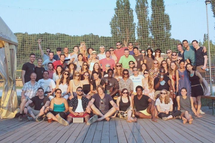 Remote Year participants in 2015. Greg Caplan, the program's founder, wearing pink but no sunglasses, is standing in the middle of the group.