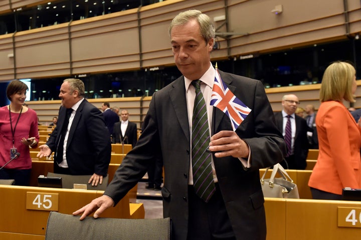 Nigel Farage holds the British flag ahead of his "facepalm address"