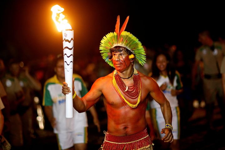 A 27-year-old man, not pictured, was arrested for allegedly trying to put out the flame as it passed through his town in central Brazil.
