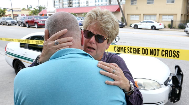 Orlando City Commissioner Patty Sheehan, right, embraces Terry DeCarlo, an Orlando gay rights advocate, as they arrive on the scene near Pulse nightclub in Orlando, Fla., on Sunday, June 12, 2016.