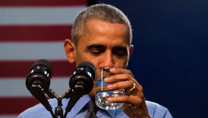 President Barack Obama drinks a glass of water as he speaks at Flint Northwestern High School in Flint, Michigan, on May 4.