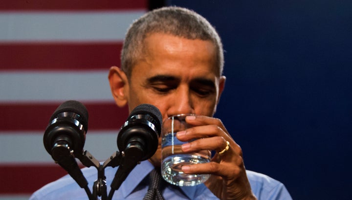 President Barack Obama drinks a glass of water as he speaks at Flint Northwestern High School in Flint, Michigan, on May 4.