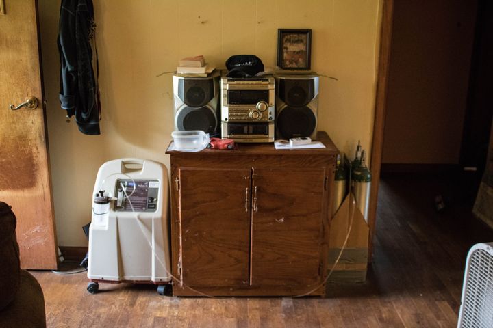 An oxygen concentrator and bottles of oxygen in the entryway of Susan Holmes' home near Bokoshe, Oklahoma.