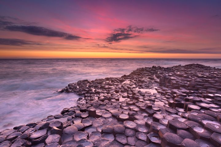 Sunset over the basalt rock formations of Giant's Causeway.