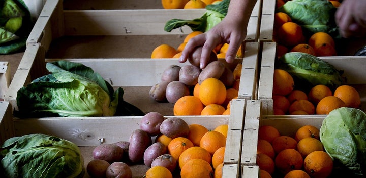 A volunteer fills up boxes with fruit and vegetables at the "Fruta Feia" (Ugly Fruit) co-op in Lisbon on March 17, 2014. The co-op was created to reduce food waste by giving another "destiny" to the fruit and vegetables that don't fit supermarket standards. In the U.S., a campaign is underway to convince Walmart to sell the same type of produce.