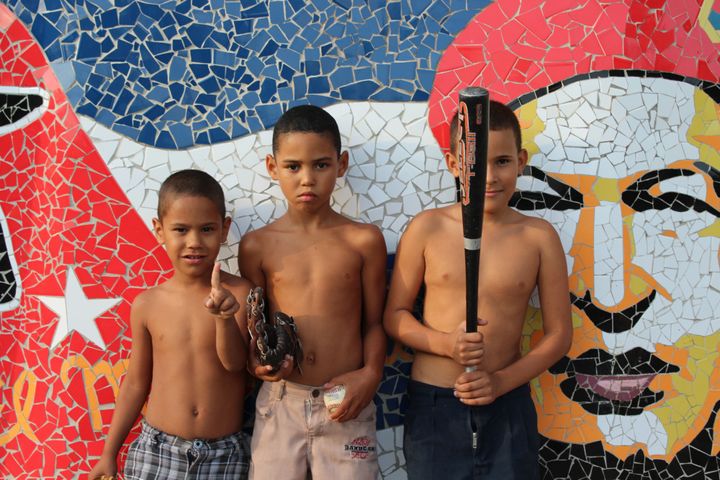While in the Fusterlandia, a Havana neighborhood with mosaic art, I managed to capture this powerful shot of local kids. The youngsters are holding a baseball set that we gave to them. 