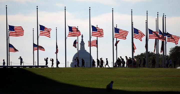Flags at the Washington Monument fly at half staff to honor those killed in last weekend's shootings at a gay club in Orlando