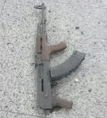 i         /A weapon is seen on the floor at the airport.