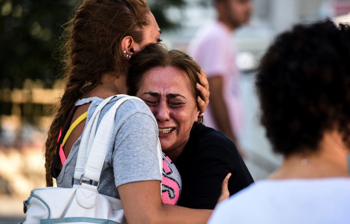 A woman cries outside a forensic medicine building close to Istanbul Ataturk Airport on June 29, a day after a trip