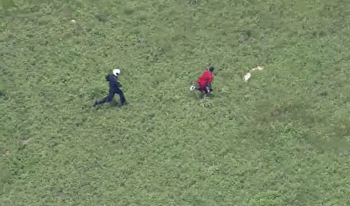 A burglary suspect is seen being chased down by a Houston tactical flight officer on Tuesday.