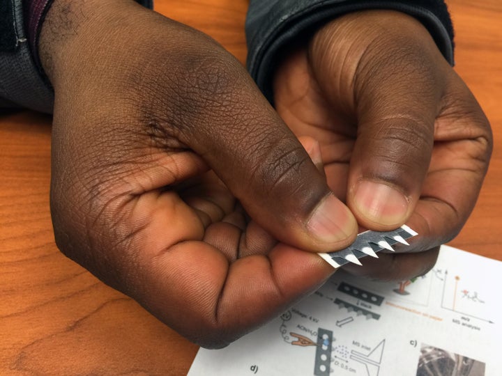 Ohio State chemist Abraham Badu-Tawiah holds a prototype test strip for diagnosing diseases including cancer and malaria.