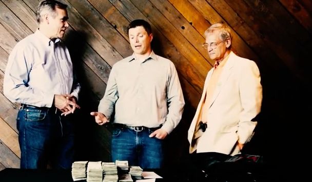 From left to right: Sen. Jeff Merkley, a pile of drug money, cannabis business owner Tyson Haworth, Rep. Earl Blumenauer