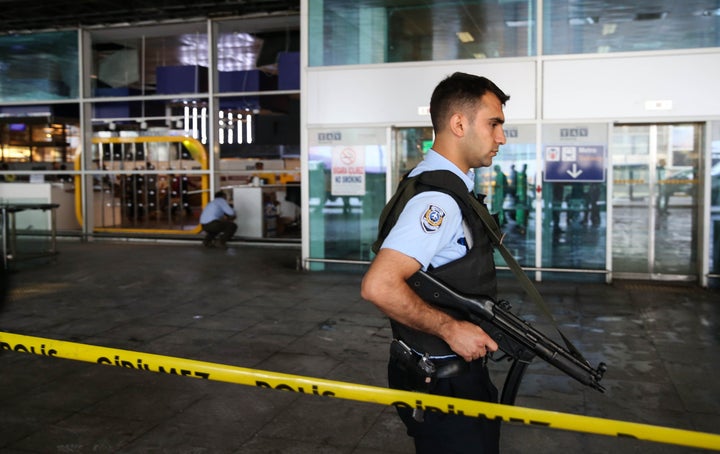 A Turkish police officer stands guard at Istanbul Ataturk Airport after air traffic returned to normal following the triple suicide bombing that killed 44 people on June 29.