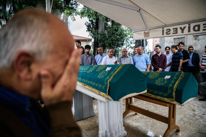 People mourn next to coffins of Maryam Amiri, Karime Amiri, Zahra Amiri and Huda Amiri on June 30, 2016 in Istanbul during their funeral two days after they were killed by a suicide bombing and gun attack targeted Istanbul's airport.