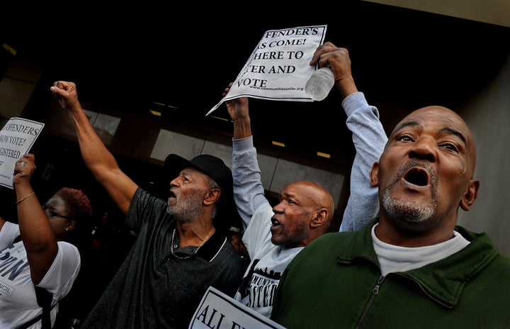 Prisoners' rights activists rally in Baltimore with several former felons and supporters to celebrate the first day