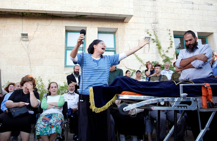 The mother of Hallel Yaffa Ariel, 13, who was killed by a 19-year-old Palestinian in the West Bank Jewish settlement of Kiryat Arba, mourns during her funeral at a cemetery in Hebron on Friday.