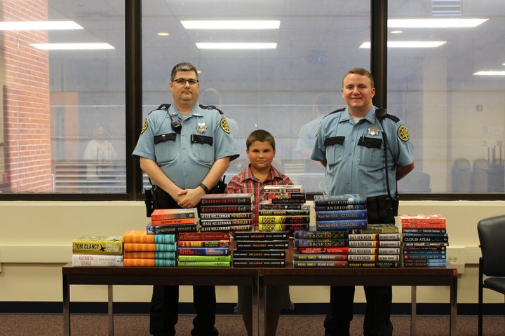 Tyler, posing with the books from the first drop-off. 