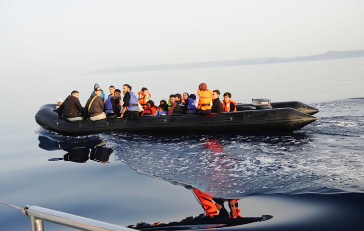 The black rubber boat has people onboard who have fled Syria, Nigeria and the Congo.