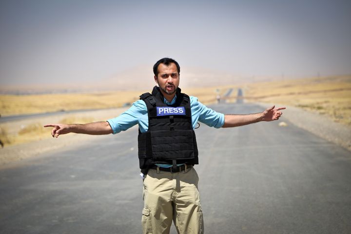 Muhammad Lila's career has taken him from the streets of Toronto to the world's hot spots. In this photo, he stands on the front lines of the battle vs. ISIS in northern Iraq.