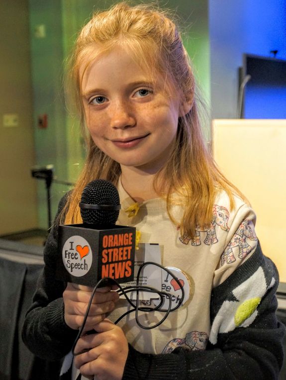 Hilde Lysiak poses with an Orange Street News mic.