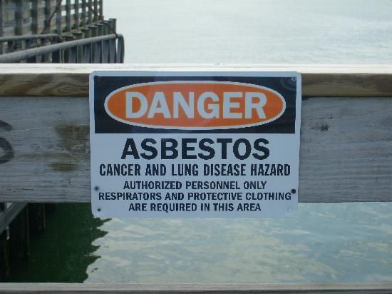 Asbestos warning sign at Peddock's Harbor in Boston, Massachusetts.