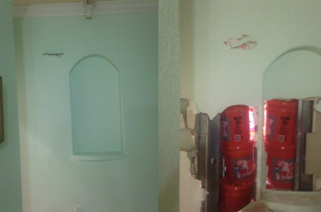 Authorities say they recovered 24 buckets filled with cash after breaking through this wall.