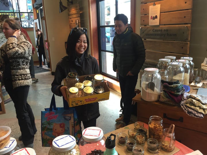 A shopper shows off her collection of glass jars at Zero Waste Market in Vancouver.