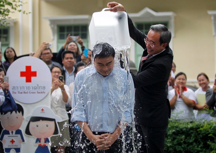 A man dumps a bucket of ice water as part of the "Ice Bucket Challenge" at the Thai Red Cross Society. The challenge, aimed at raising awareness and money to fight ALS, was largely popularized on Facebook.